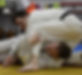 Two men sparring in groundwork at ju-jitsu class