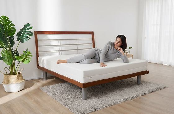 woman testing natural latex mattress thickness_edited.jpg