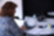 Professional woman working on laptop with documents at coworking space in Melbourne business centre