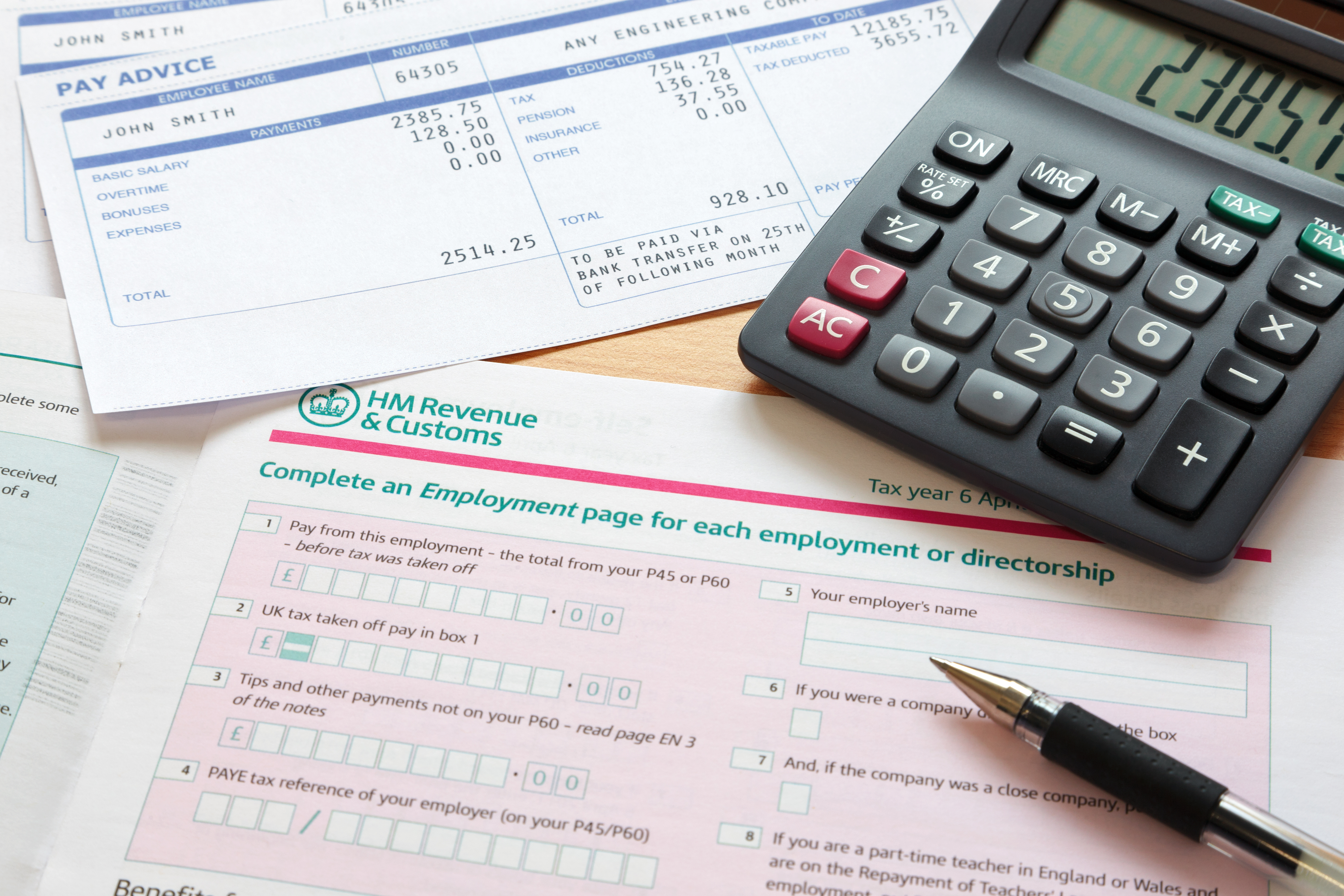 UK self assessment tax return with calculator and payslips