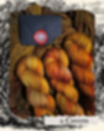 Thumbnail: Hand-dyed yarn skeins in gold, orange and warm brown with a wax-sealed envelope, inspired by caves.