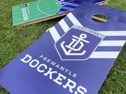 Football Club Fremantle Dockers ordering a set of custom branded cornhole boards for their event in Perth