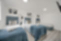 Three beds inside a modern room with decorative mirrors, white walls. Jry Property Group.
