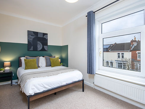 Modern bedroom interior by WJO Stays with large window.