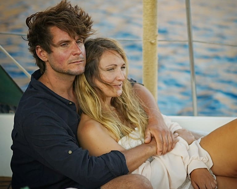 Couple on a sailboat hugging
