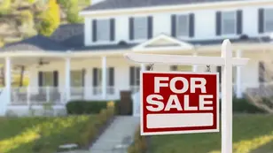 For Sale sign in front of a home illustrating the benefits of roof cleaning before selling your home.