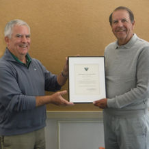 Vince McDermott, newly elected chairman, presents outgoing chairman John Lacadie with a Certificate 