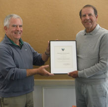 Vince McDermott, newly elected chairman, presents outgoing chairman John Lacadie with a Certificate