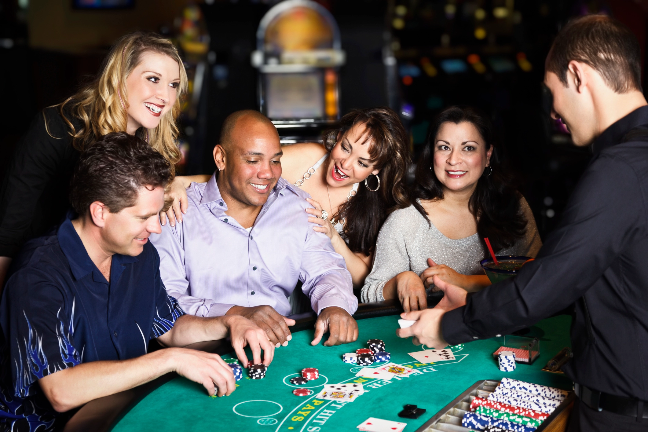 A table of adults enjoy a poker game