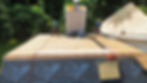 Roofing workers installing materials on a residential roof construction site,