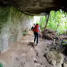 Guest-trekking-overhanging-rock-landak-river.jpg