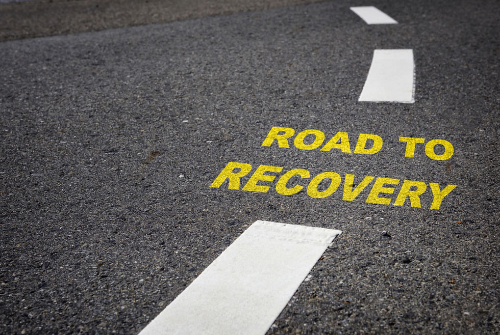 a road that says 'road to recovery' in yellow