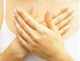 Woman with both hands over her heart, feeling her emotions
