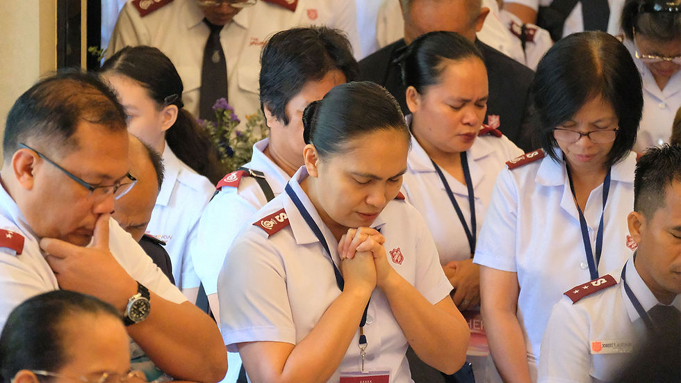 Officers of the Philippines Territory pray during the Appointment and Celebration service.