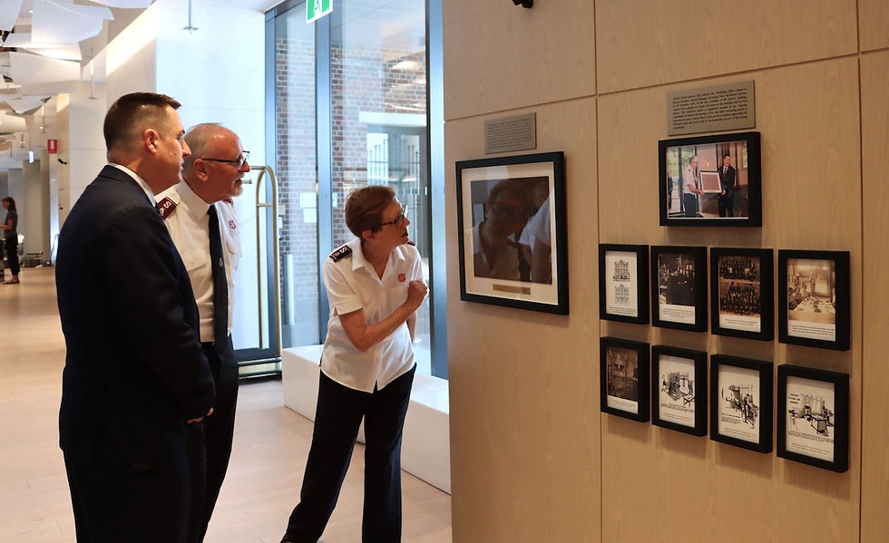 (From left) Marcus Packham (General Manager Lanson Place), Colonel John Chamness and Commissioner Miriam Gluyas admiring the Salvo Wall.
