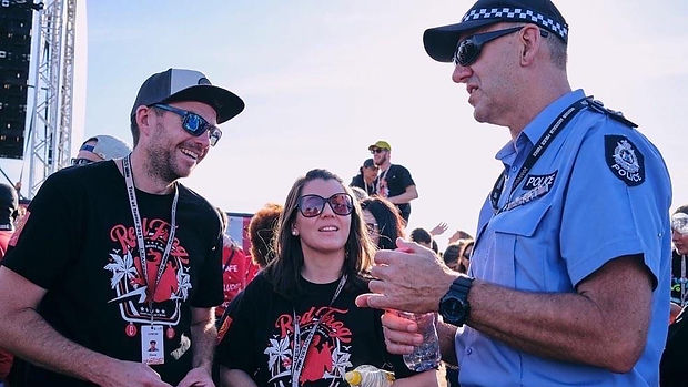 Aux-Lieutenants Steve and Marenda Freind chat with a police officer during a recent youth event where they served with the Red Frogs Crew.
