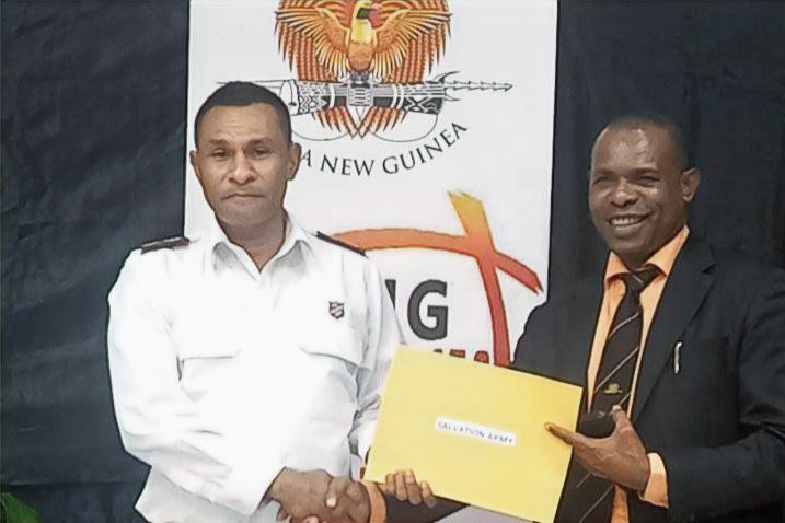 Major Gaina Vali accepts the government donation from Minister Jason Peter.