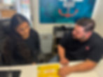 Lieutenant Keven Williams speaks with a volunteer about the ‘word of the week’, and how to engage community members in meaningful conversations around it.