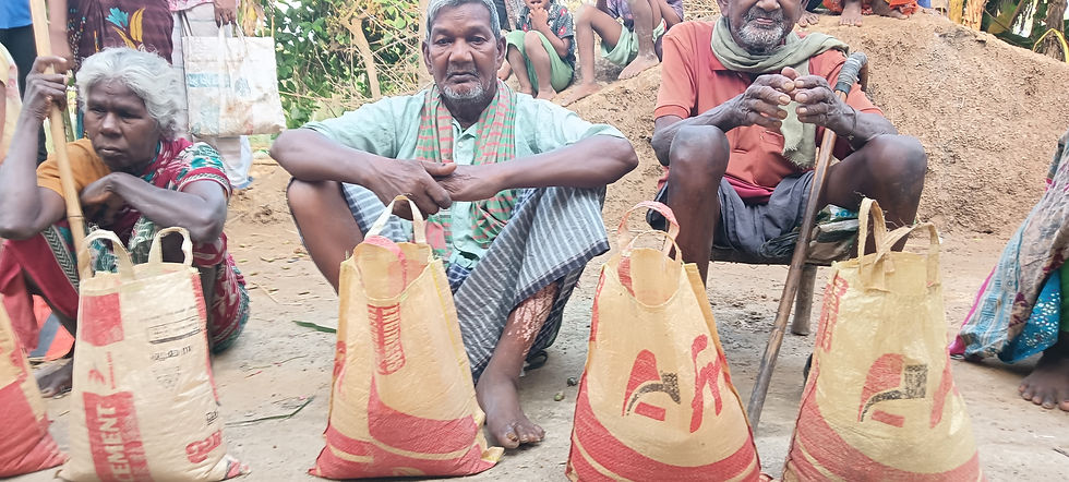 "Three elderly villagers — two men and a woman — sit on the ground outdoors in Bangladesh, each with a large filled food relief bag in front of them, patiently waiting during a rice distribution event."