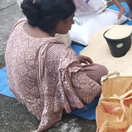 Lotus Ministry Trust Volunteer Bagging Rice