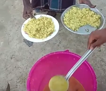 "A close-up of hands serving khichdi onto plates from a large pink bucket."