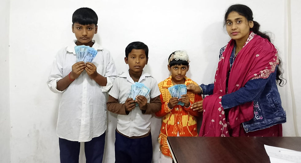 "A young woman hands cash relief stipends to three children — two boys and a girl — each holding a small stack of banknotes, during an indoor orphan assistance distribution in Bangladesh."