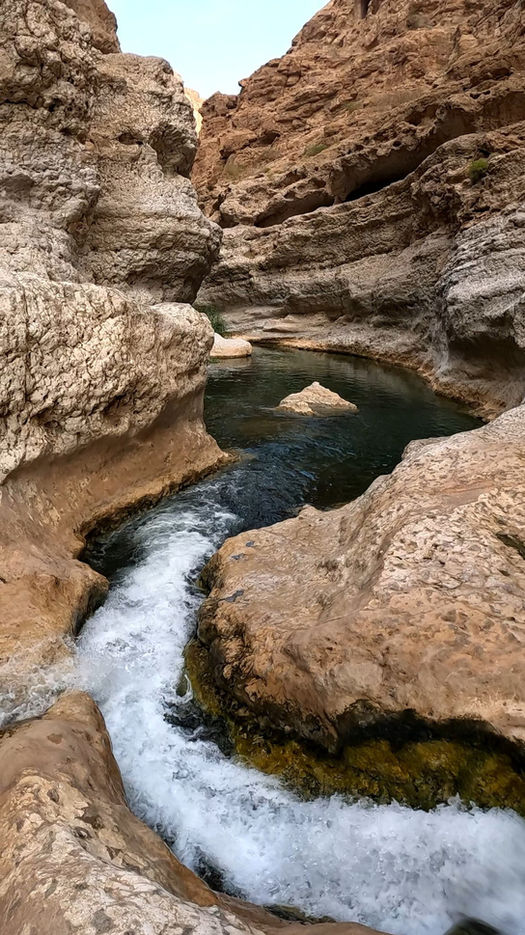 1-day Oman nature tour visiting Wadi Shab, Romantic Cave, and Bimmah Sinkhole with turquoise pools and scenic cliffs.