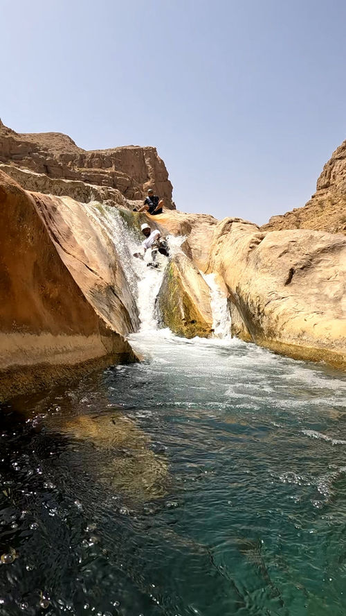 Small waterfall and deep canyon pool along the Wadi Hawer canyoning route
