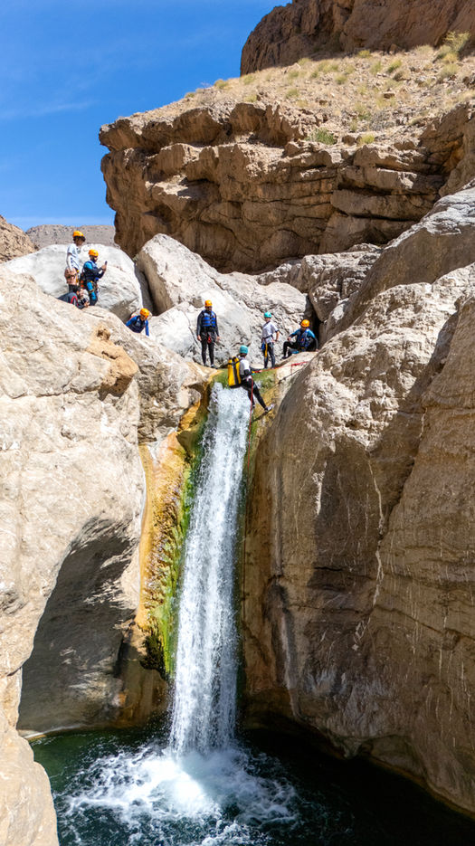 Canyoning in Wadi Hawer Oman with natural waterfalls, clear pools, and wild mountain views on a 1-day adventure.