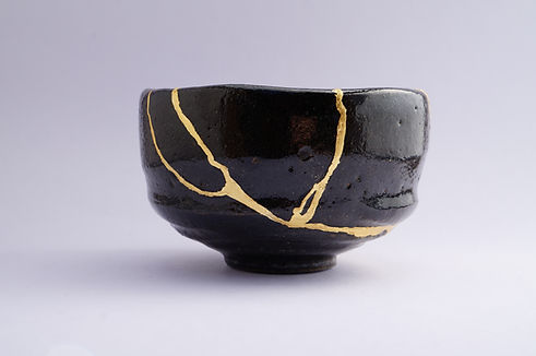 Antique black and gold Kintsugi bowl Gold cracks restoration on old Japanese pottery resto