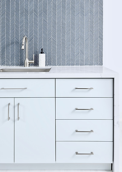 Laundry Room Counter with Herringbone Glass Backsplash