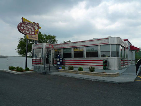 Open-faced turkey sandwiches covered in brown gravy at a classic 1980s diner, inspired by a college story about two broke friends ordering second helpings at the Elite Diner in Urbana.