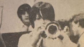 Black-and-white photo of junior high jazz band with student playing trumpet during school performance