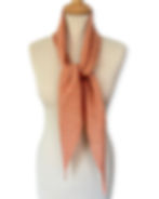 orange and grey striped skinny scarf on a mannequin