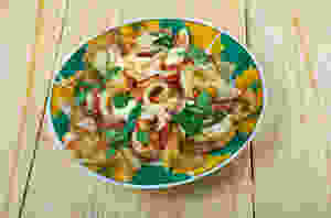 Chilaquiles topped with red sauce
