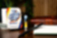 Rosin King of Jersey Live Rosin vape cartridge and branded tin on a desk beside a leather journal, pen, and potted plant—premium 500mg rosin cartridge with bold NJ branding.