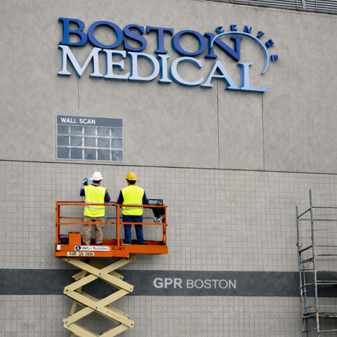 Technicians scanning Boston Medical Center exterior wall with GPR