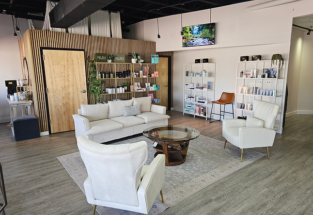Salon Evolve reception area with white seating and haircare product displays
