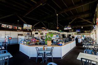 Open-air dining area with marina view at Harbor House Kona