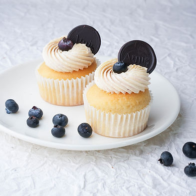 Eggless Vanilla cupcake filled with juicy blueberries and topped with a smooth vanilla frosting & fresh blueberries, creating a delightful combination of flavors.