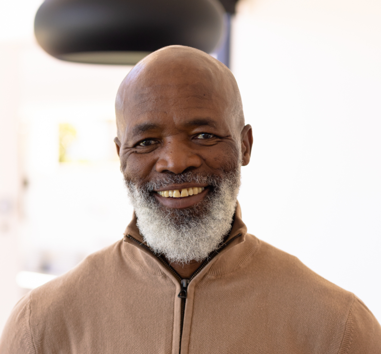 senior-african-american-man-standing-with-hands-hips-modern-living-room-pendant-lamp_edite