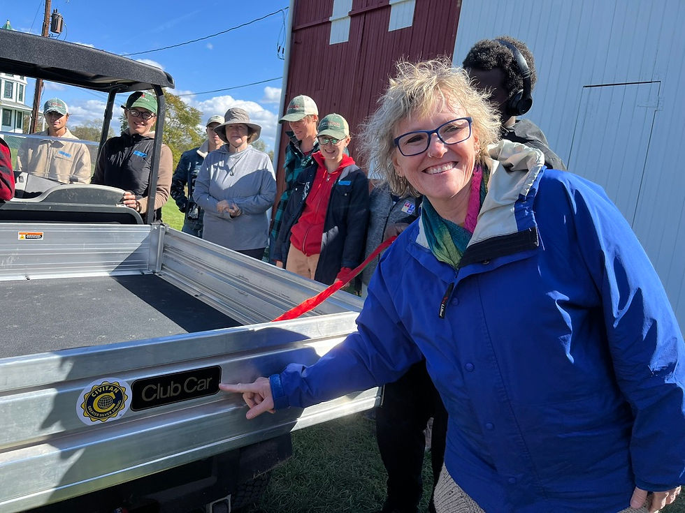 Audrey Dumentat celebrating a new cart for farm work at Red Wiggler and spending time on the Pacific Coast