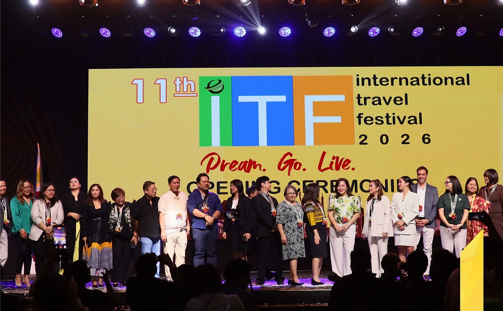 A zoomed-out photo of the stage of the International Travel Fair in Cebu, showing various delegates and executives of the event.