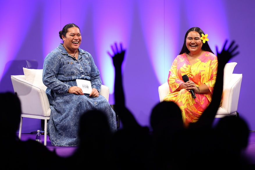 Youth Leader Tylah Farane-Watene and climate activist Biranna Fruean on stage with audience hands raised in the air