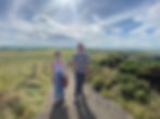 Two people on a path in sunny nature, for nature-based wellness