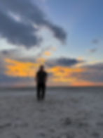 person standing on salt flats at Jacks Camp in Botswana embracing nature-based wellness