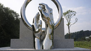 Mirror-polished forged stainless steel sculpture with stone base