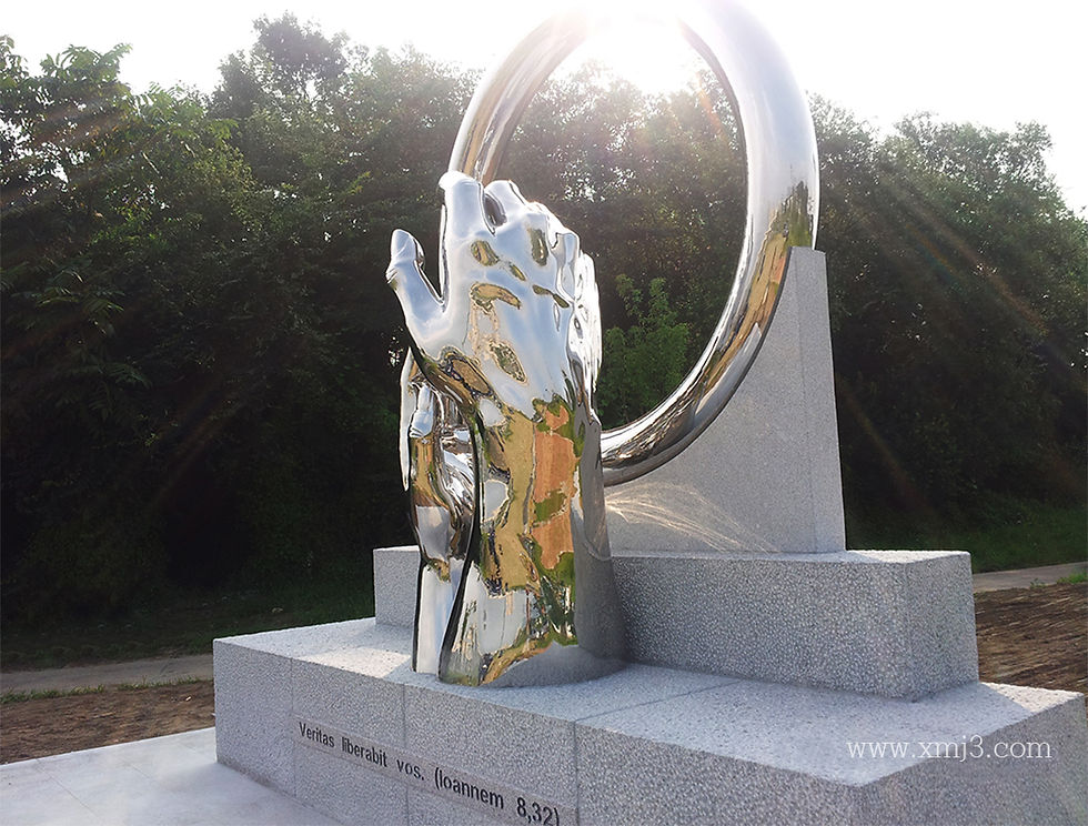 Forged stainless steel sculpture reflecting natural sunlight