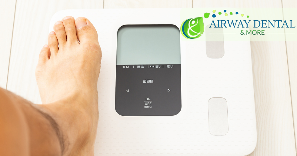 man stepping on a scale to weigh himself