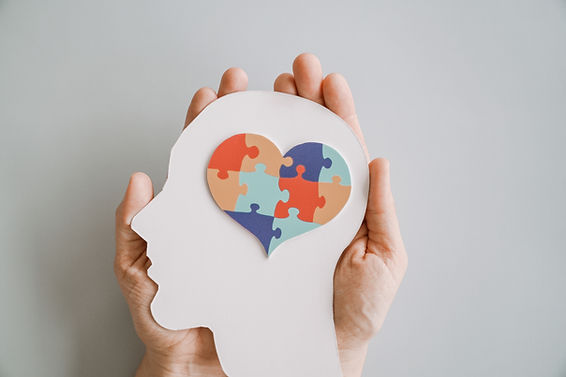 Hands holding jigsaw puzzle heart shape in brain Autism awareness, neurodiversity concept,